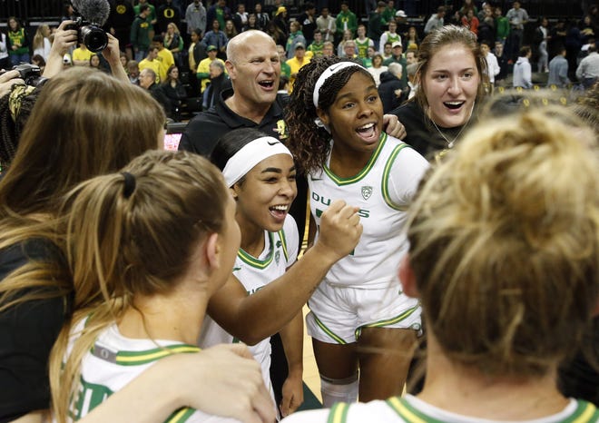 Oregon coach Kelly Graves, Minyon Moore, Ruthy Hebard and Sedona Prince celebrate the Ducks' 87-55 win over Stanford on Jan. 16 at Matthew Knight Arena. [Andy Nelson/The Register-Guard] - registerguard.com