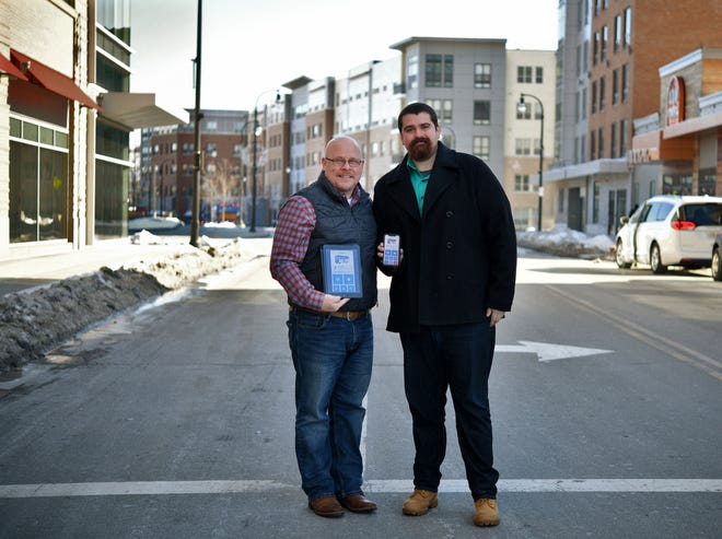 Aaron Perna and Ben White stand on Front Street on Monday, January 20, 2020 with the "Ride the Woo" app opened. The two men are launching a trolley route in the City. [T&G Staff/Christine Peterson]