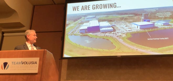 Blue Origin executive Scott Henderson talks about the private rocket company's growth at Team Volusia Economic Development Corp's annual meeting on Jan. 23, 2020. On the screen is a rendering showing Blue Origin's facilities at Cape Canaveral Air Force Base. [News-Journal/Clayton Park]