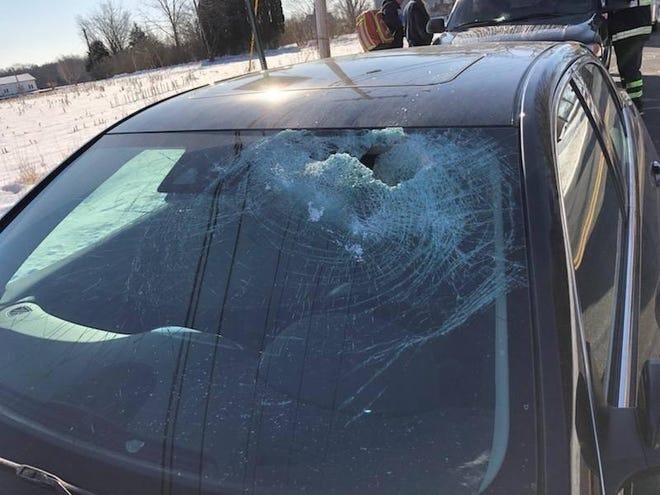 This vehicle's windshield was smashed by a block of ice that fell off a moving truck ahead of it on South Walker Street in Taunton in March 2019. [Taunton Police photo]