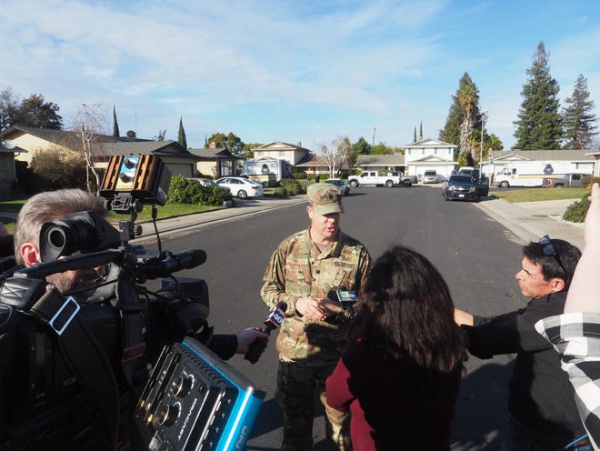Air Force Lt. Col. Glenn Cameron, squadron commander for the 60th Civil Engineering Squad out of Travis Air Force Base, gives an update to an investigation outside a home on the 2900 block of Rockford Avenue where a large trove of military-style weapons discovered the day before mostly turned out to be replicas. Each item had to be treated as live and individually inspected to ensure public safety, Cameron said. [CALIXTRO ROMIAS/THE RECORD]