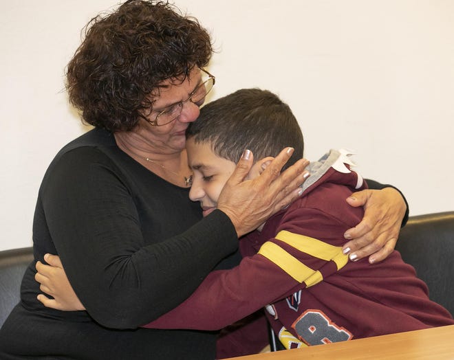 Luz Torres gives her son Yometh, 11, a hug and kiss while getting a little emotional on Wednesday. Mother and son moved to Ocala from Puerto Rico so Yometh could secure medical care. Community with a Heart has helped them settle into their own apartment by paying the security deposit and TECO Gas fee. [Doug Engle/Staff photographer]