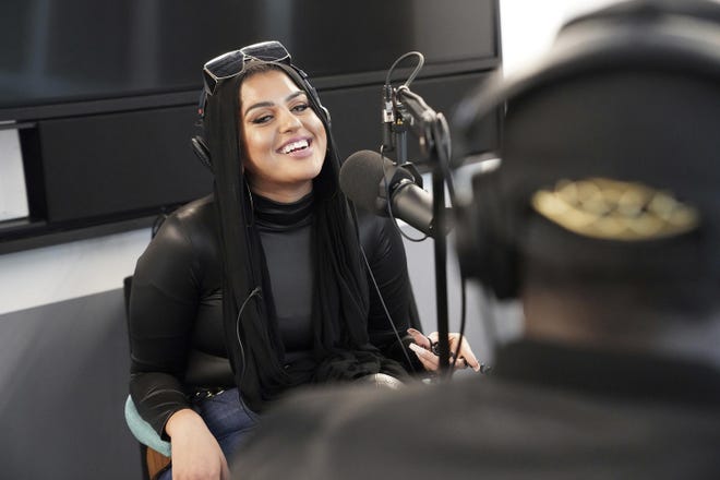 In this Dec. 19, 2019, photo, Amani Al-Khatahtbeh, founder of Muslimgirl.com, records a podcast pilot at Spotify's headquarters in New York. On her site, Al-Khatahtbeh is especially proud of stories that deal with race and sexuality. “Of course, female sexuality is honored within our religion, and it shouldn't be something we shy away from or think of as a taboo.” (AP Photo/Emily Leshner)