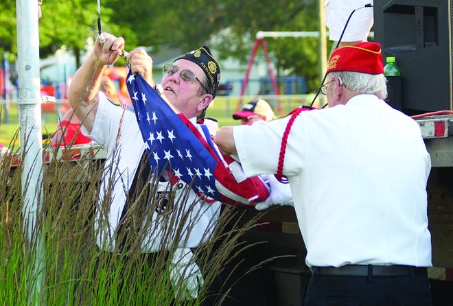 Members of the Kewanee American Legion hoist the flag during the Fourth of July celebration at Northeast Park.