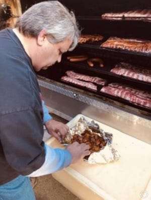 William "Bill" Neumeier Jr. making his award-winning ribs. [PHOTO COURTESY OF THE NEUMEIER FAMILY]