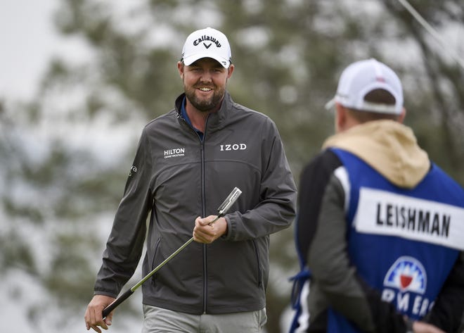 Marc Leishman smiles after putting on the fourth hole of the South Course at Torrey Pines during the final round of the Farmers Insurance Open on Sunday in San Diego. [Denis Poroy/Associated Press]