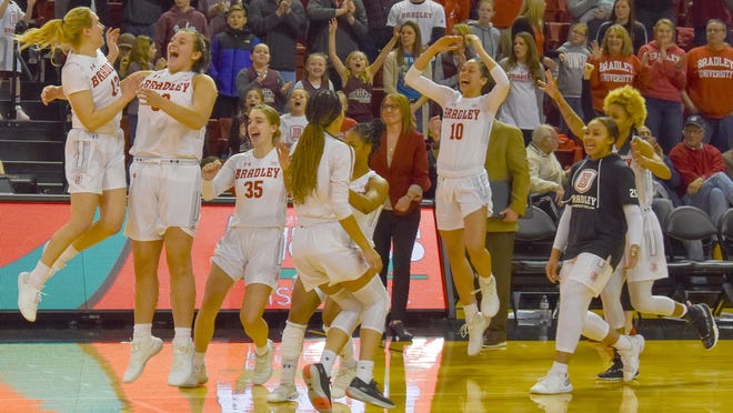 The Bradley women's basketball team celebrates after a 77-76 victory over Drake on Sunday at Renaissance Coliseum in Peoria. [JOSH SCHWAM/BRADLEY ATHLETICS]