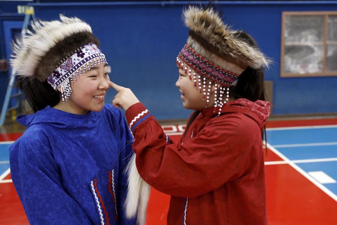 Rosmary Henry (left) and Kaziah Therichik prepare for an Alaska Native dance in honor of the arrival of Census bureau director Steven Dillingham on Tuesday in Toksook Bay, Alaska. The 2020 census got underway last week in rural Alaska. The census always starts in remote parts of the nation's largest state out of tradition and necessity. (Associated Press / Gregory Bull)
