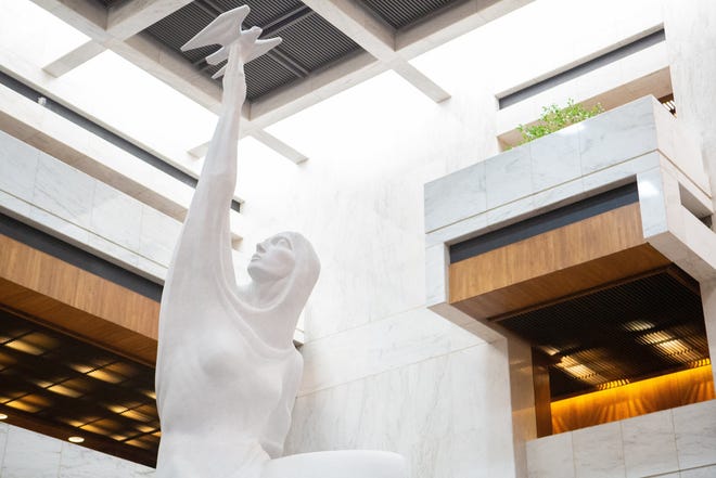 The atrium of the Kansas Judicial Center in Topeka is dominated by the sculpture "Justice." It depicts a kneeling woman holding aloft a native Prairie Falcon, one of the swiftest birds known, whose vision is thought to be eight times more powerful than a human's. [Evert Nelson/The Capital-Journal]