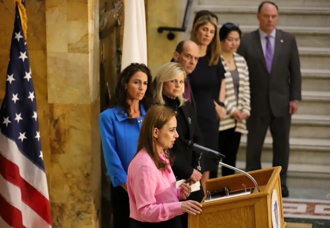 Political strategist Julie Roginsky (at podium), journalist Gretchen Carlson, and attorney Mitchell Garabedian were among those voicing support Monday for Sen. Diana DiZoglio's bill to restrict use of non-disclosure agreements on Beacon Hill. [Photo: Sam Doran/SHNS]