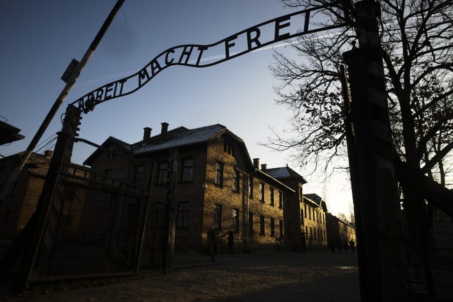 FILE - In this Dec. 6, 2019, file photo, the sun lights the buildings behind the entrance of the former Nazi death camp of Auschwitz-Birkenau in Oswiecim, Poland. World leaders will gather twice to mark the 75th anniversary of the liberation of the Auschwitz-Birkenau concentration camp _ once on Thursday, Jan. 23, 2020, in Jerusalem and again on Jan. 27 at the Auschwitz site in southern Poland. The fact that there will be two competing ceremonies reflects how politically charged World War II remains for nationalist governments in Russia and Poland. (Photo/Markus Schreiber, File)