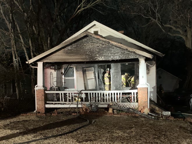 A woman and her dog and cat escaped a burning house early Tuesday at 1524 S.W. Collins. No injuries were reported. [Phil Anderson/The Capital-Journal]