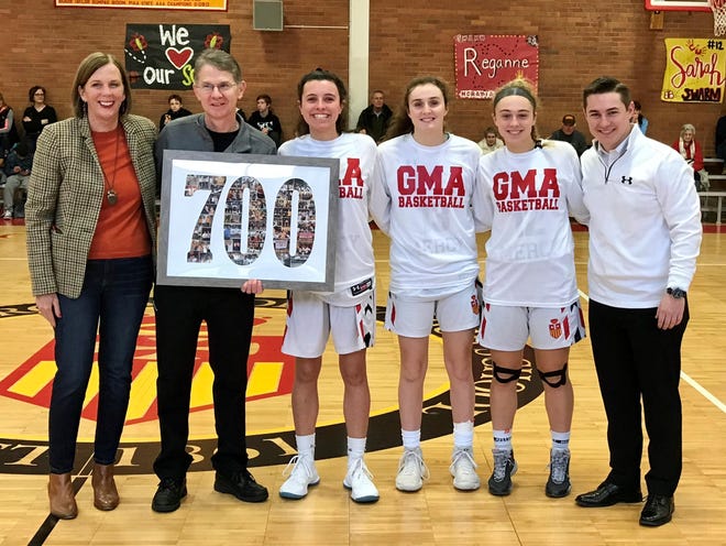 From left: Denise Marbach, president of Gwynedd Mercy Academy, Coach Tom Lonergan, seniors Reganne Flannery, Mollie Hanson, Sarah White, former GMA assistant and current John Paul II coach TJ Lonergan, who is also Tom’s son, celebrate Lonergan’s 700th career girls basketball win. [MARY JANE SOUDER / PHOTOJOURNALIST]