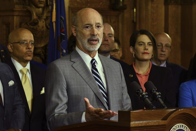 Gov. Tom Wolf speaks at a news conference in his Capitol offices as he unveils a $1.1 billion package intended to help eliminate lead and asbestos contamination in Pennsylvania's schools, homes, day care facilities and public water systems, Wednesday in Harrisburg. Looking on are Democratic state lawmakers and officials from teachers' unions. [AP Photo/Marc Levy]