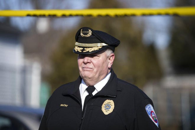 Morrisville police Chief George McClay walks from the Robert Morris Apartments after five relatives were found murdered in the complex in February. [MATT ROURKE / THE ASSOCIATED PRESS]