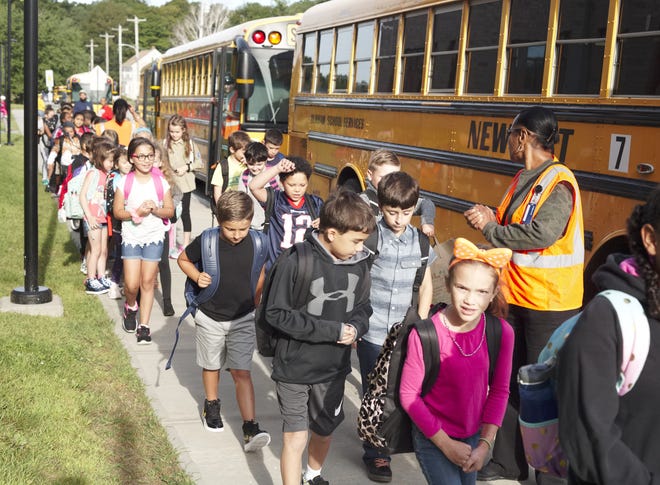 School bus drivers unload the buses for the first day of school at Pell Elementary in Newport. [PETER SILVIA PHOTO]