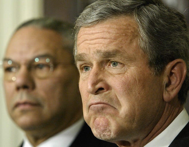 The game is over, declares President Bush as he reaffirms his commitment to ridding Iraq of its leader Saddam Hussein during remarks in the Roosevelt Room at the White House on Feb. 6, 2003. He is joined at left by Secretary of State Colin Powell who presented the U.S. case against Iraq to the United Nations the day before. [J. Scott Applewhite/The Associated Press]