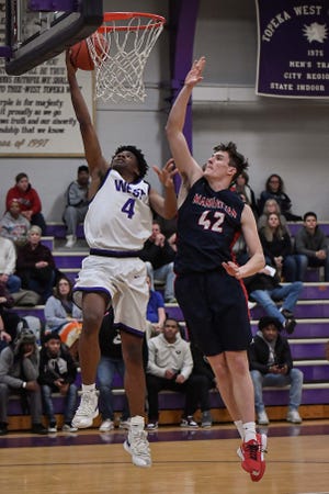 Topeka West's Elijah Brooks (4) slips past Manhattan's Chandler Marks for a basket in Wednesday's 53-52 Charger win. [Rex Wolf/Special to The Capital-Journal]