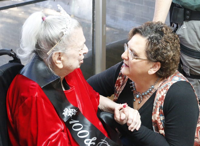 Ruby Jo Shelton gets a birthday wish from her granddaughter, Kerry Peevy of Brownwood, as her family and the staff and residents of Brownwood Nursing and Rehabilitation celebrate Shelton's 100th birthday Wednesday. [Photo by Steve Nash]