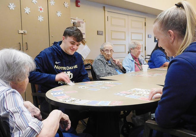 Notre Dame High School students joined Valley Residential Services residents for cards Wednesday as part of Catholic Schools Week. Pictured sitting second from left is John Buschmann, a Notre Dame High School student, along with Sam Fluty, pictured sitting on right, also a student. [STEPHANIE SORRELL-WHITE/TIMES TELEGRAM]