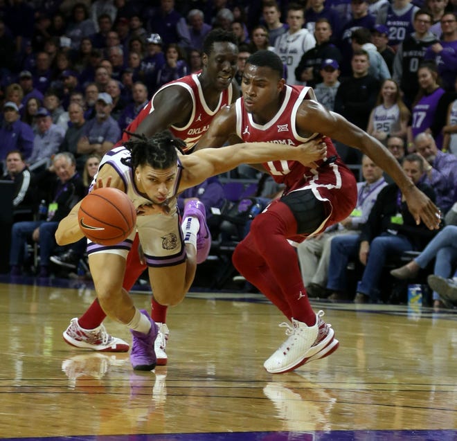 Kansas State guard Mike McGuirl (00) is fouled by Oklahoma's De'Vion Harmon (11) during the first half Wednesday night at Bramlage Coliseum. McGuirl scored a team-high 16 points in the Wildcats' 61-53 victory. [SCOTT SEWELL/USA TODAY SPORTS]