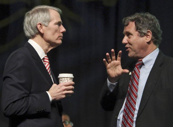 Ohio Sens. Rob Portman (left) and Sherrod Brown talk at a Columbus event. (Dispatch file]photo by Eric Albrecht)