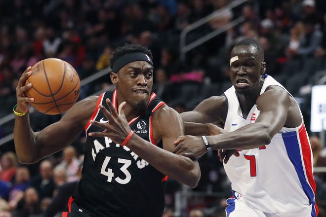 Detroit Pistons forward Thon Maker (7) reaches in and fouls Toronto Raptors forward Pascal Siakam (43) during the first half of an NBA basketball game Friday, Jan. 31, 2020, in Detroit. (AP Photo/Carlos Osorio)