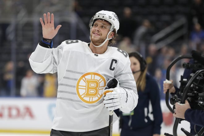 Boston Bruins forward David Pastrnak waves to the crowd as he is named the most valuable player of the NHL hockey All Star games Saturday, Jan. 25, 2020, in St. Louis. (AP Photo/Jeff Roberson)