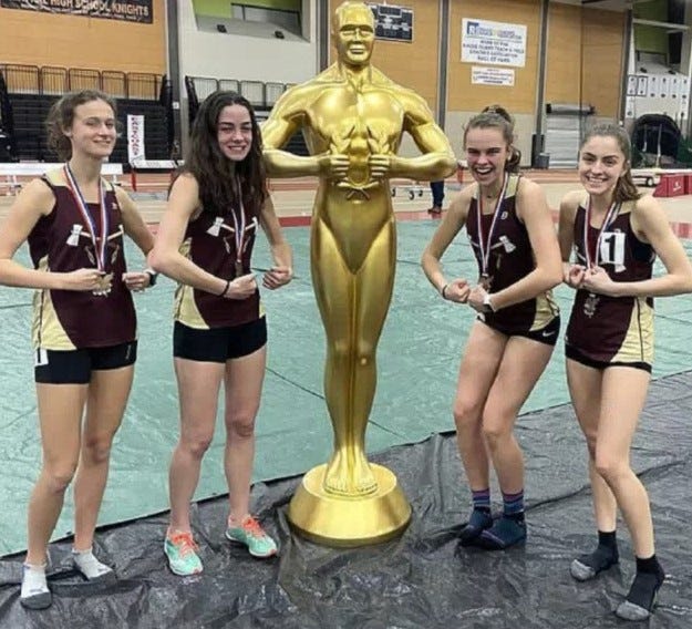 The Algonquin girls' 3,200-meter relay team flexes after its win at the East Coast Invitational last week in Springfield. [Photo/Algonquin Athletics]