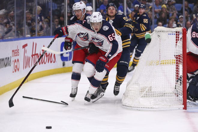 Blue Jackets defenseman Markus Nutivaara (65) loses his stick while being hounded by Sabres forward Jeff Skinner. [Jeffrey T. Barnes/The Associated Press]