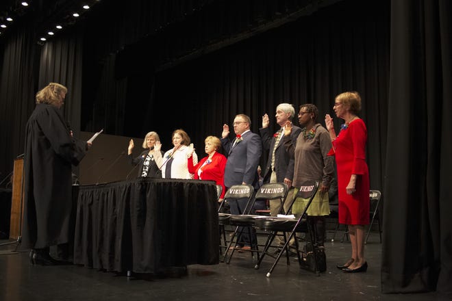 Newport School Committee members take the oath of office officiated by District Court Judge Colleen Hastings during the joint inauguration ceremony at Rogers High School. [PETER SILVIA PHOTO]
