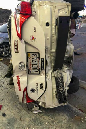 A damaged white Toyota Corolla lies on its side after a crash at a Chevron gas station in Oak Hills on Sunday, Feb. 2, 2020. [PHOTO COURTESY OF BILL VAN HEEST]