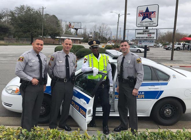 Members of the Onslow County Highway Patrol recently visited with Jacksonville Police Department Officer X. Y. Brown, who has served the community of Jacksonville since 1956. The visit afforded the patrol members an opportunity to reflect on the past while building partnerships with local agency members. [Photo courtesy of the N.C. Highway Patrol]
