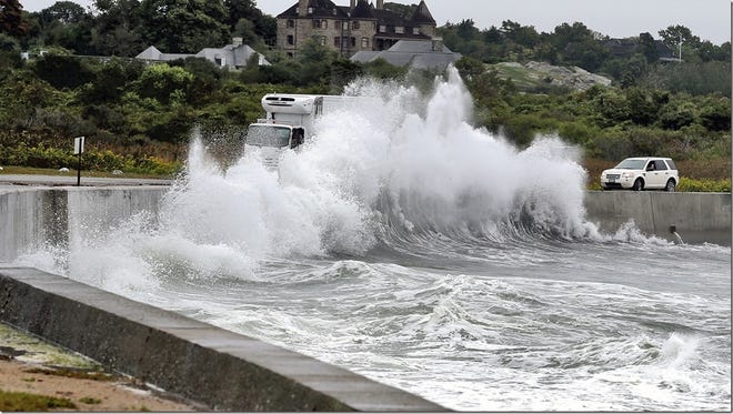 A wave crashes into the seawall. [ED PEPIN PHOTO]