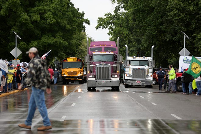 Trucks and tractors head toward the Oregon Capitol on June 27, 2019 in Salem. Opponents of proposed cap-and-trade legislation are planning a multi-city truck convoy and a rally Thursday at the Oregon Capitol. [Michaela Roman/Statesman-Journal via AP file]