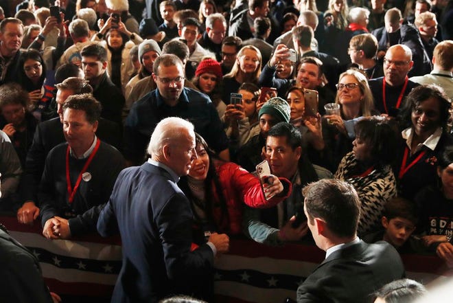 Democratic presidential candidate former Vice President Joe Biden walks in the crowd at a caucus night campaign rally on Monday in Des Moines, Iowa. (AP Photo/John Locher)