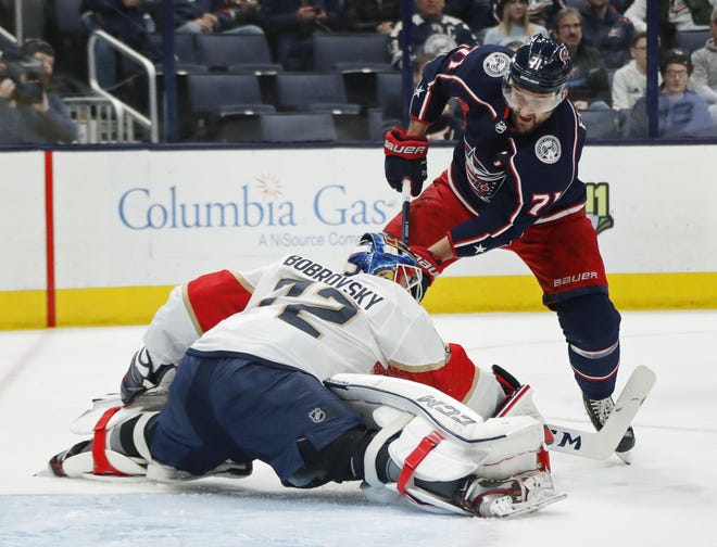 Panthers goaltender Sergei Bobrovsky gets low and wide to stop a shot by Blue Jackets left wing Nick Foligno during the first period Tuesday night at Nationwide Arena. [Adam Cairns/Dispatch]