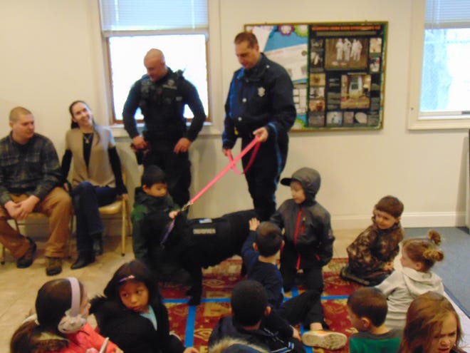 Mass. State Trooper Jayson Gallup, left, and Trooper Chad Tata, with comfort K-9, Luna, speak to the children during the Junior Trooper Program at the Massachusetts State Police Museum and Learning Center Saturday, Jan. 25, 2020. [Submitted Photo]