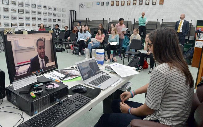 East Henderson High student Chloe Brown asks a question of composer and conductor Rollo Dilworth, vice dean and professor of choral music education at Temple University Monday morning via Skype.