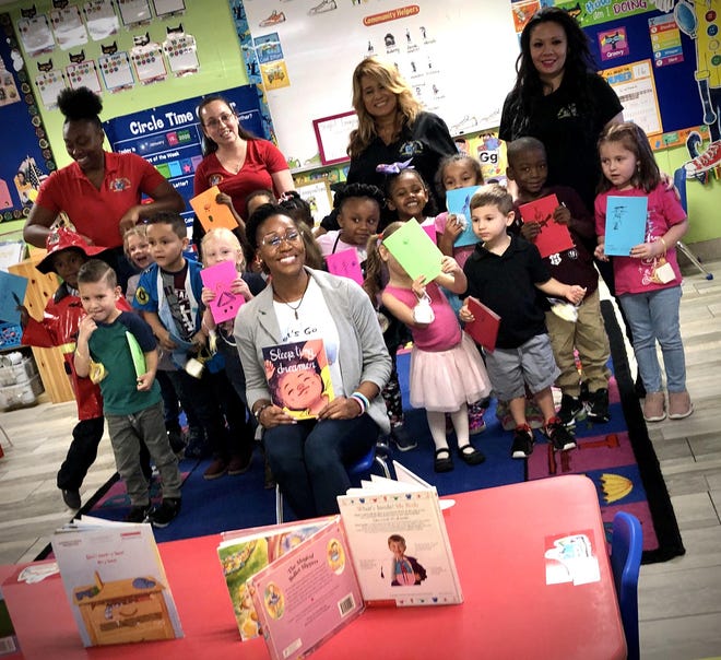 Students and staff of Bright Imaginations School in Lakeland pose with local author Shanita Allen recently after reading to her their book of dreams. [KIMBERLY C. MOORE/THE LEDGER]