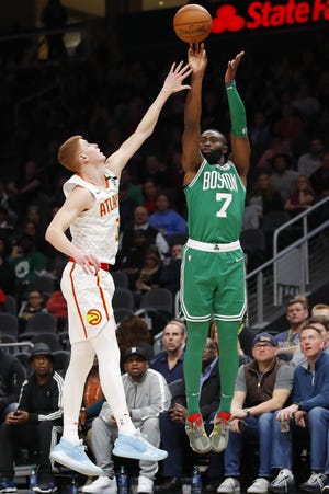 Celtics guard Jaylen Brown (right) shoots as Hawks guard Kevin Huerter defends in the first half of Boston's . [AP Photo/Todd Kirkland]