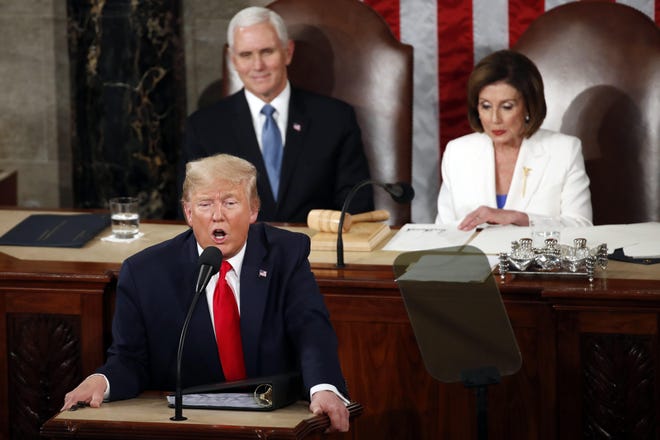 President Donald Trump delivers his State of the Union address to a joint session of Congress on Capitol Hill in Washington on Feb. 4, 2020, as Vice President Mike Pence listens and House Speaker Nancy Pelosi of Calif., reads. (AP Photo/Alex Brandon)