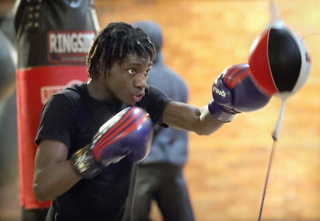 Tyshawn Denson throws a jab at a speed bag during a workout last month in Akron. [Phil Masturzo/Beacon Journal]