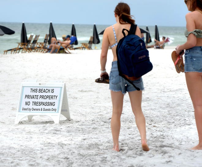 Emily Shriner (left) and Madison Blackstock of Nashville, Tennessee, were unsure where they could sit on the beach near the Blue Mountain Beach access. [FILE PHOTO/DAILY NEWS]