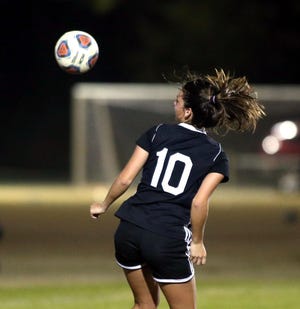 Niceville's Ashlyn Fernandez heads the ball into the goal during a playoff win last year. [MICHAEL SNYDER/DAILY NEWS]