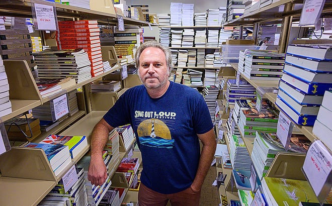 Flagler College bookstore owner Trevor Smith stands in his business on the school’s campus on Monday. The school has decided to replace Smith’s shop, which has been run by his family since 1978, with a Barnes & Noble at the end of the month. [PETER WILLOTT/THE RECORD]