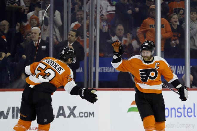 The Flyers' Claude Giroux, right, and Shayne Gostisbehere celebrate a Giroux goal. [MATT SLOCUM / ASSOCIATED PRESS FILE]