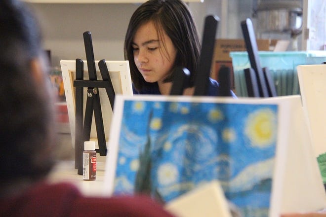 Grace Lemos, 11, focuses on her painting on Tuesday, Feb. 4, during Herrick District Library's Teen Art Club. [Brian Vernellis/Sentinel staff]