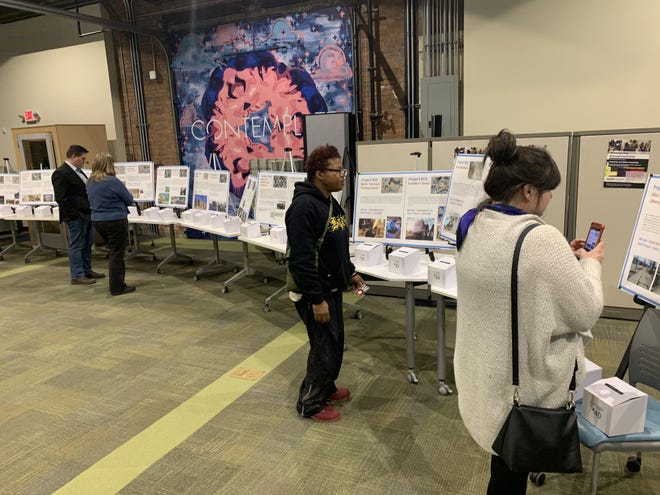 Members of the public review project proposals at a Utica Downtown Revitalization Initiative open house Thursday, Feb. 6, 2020, at the thINCubator in Utica. [STEVEN HOWE / OBSERVER-DISPATCH]