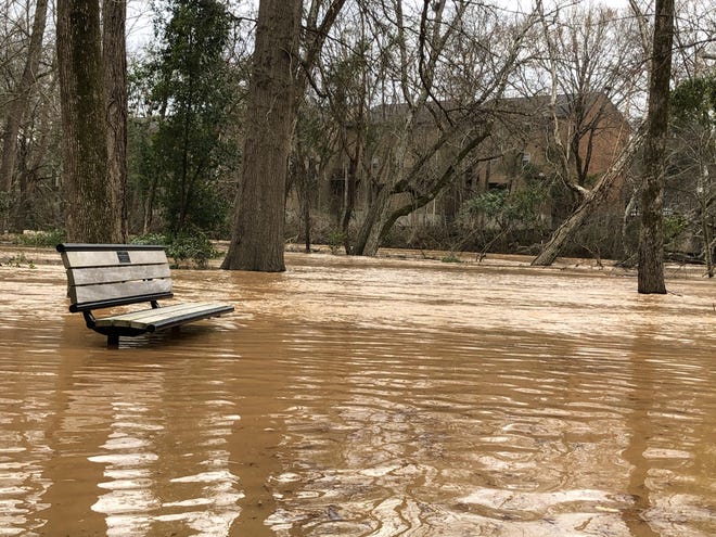 The North Oconee River is shown flooding Friday afternoon at Dudley Park in Athens. Heavy rains from counties north of Athens pushed the waters over the bank. [Ryne Dennis/Athens Banner-Herald]